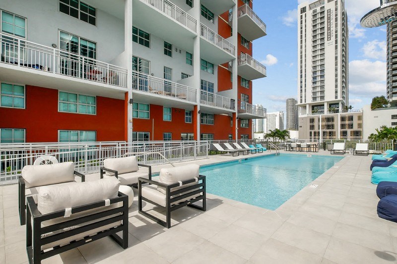 a swimming pool in front of a building