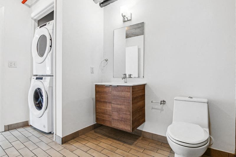 a bathroom with a toilet sink and a washing machine