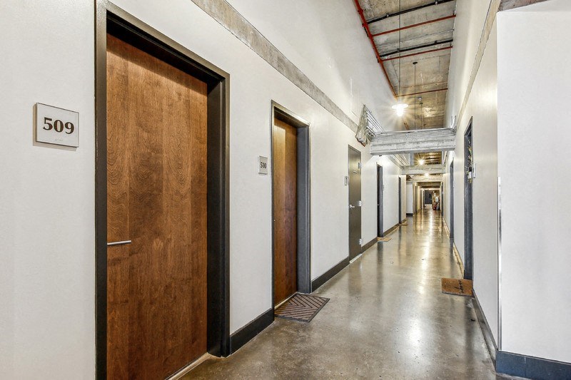 a corridor of elevators and doors in a building