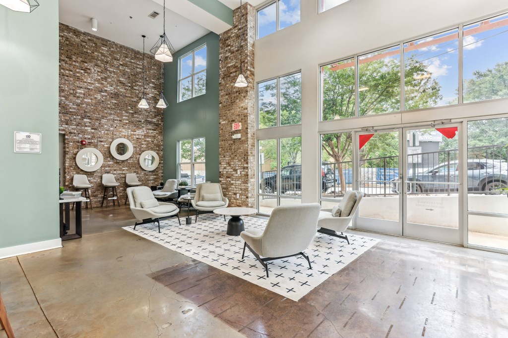 A room with a brick wall and a large window.