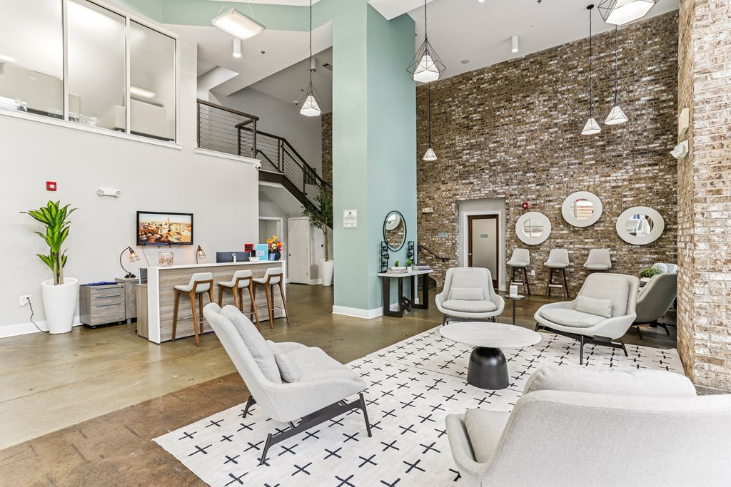 A room with a brick wall and a couch.