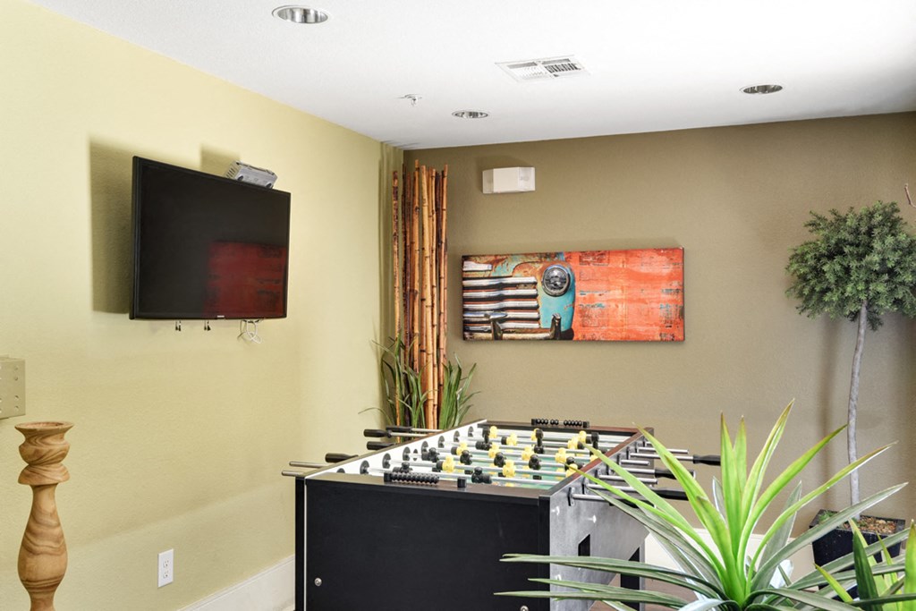 a game room with a chess board and a tv