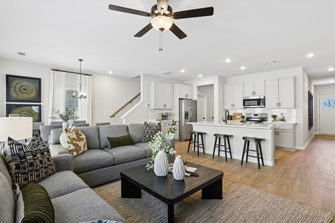 A modern living room with a grey sofa and a black coffee table.