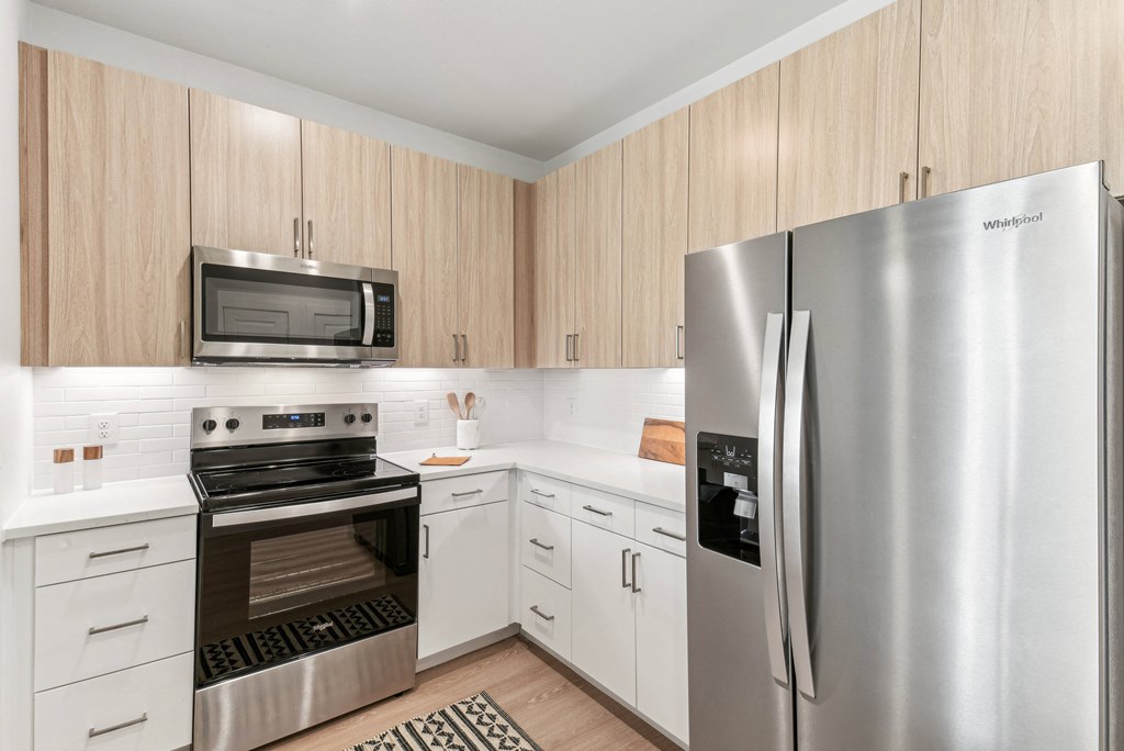 A kitchen with a stainless steel refrigerator and oven.