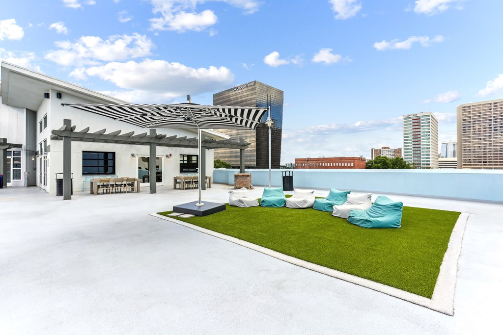 A white building with a green lawn in front.