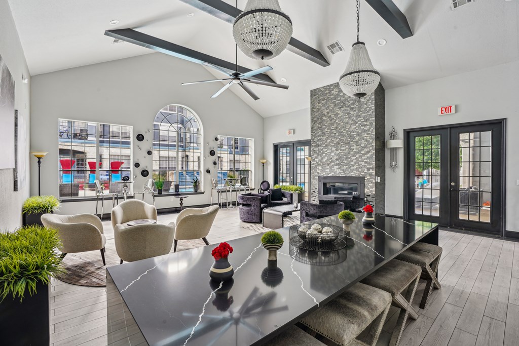 A modern dining room with a glass table and chairs.