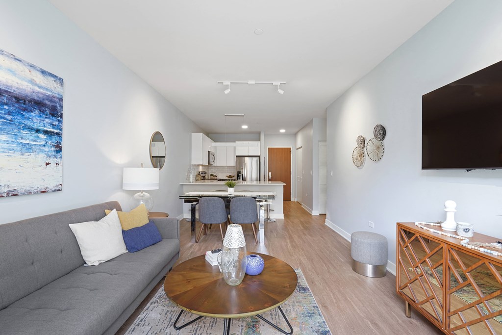 a living room with white walls and hardwood floors