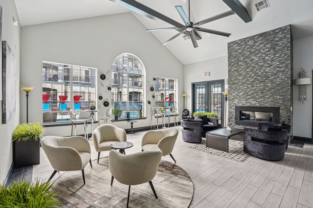 A modern living room with a fireplace and a view of a balcony.