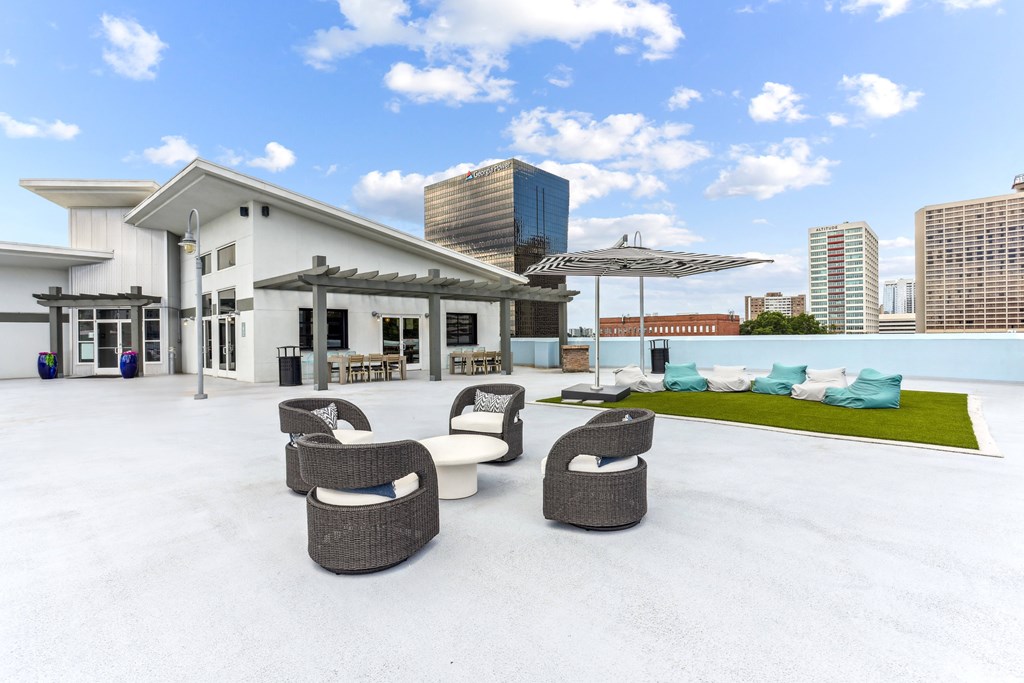 A white building with a patio area in front.