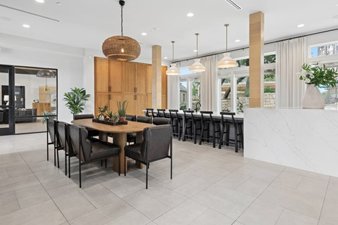 A modern dining area with a wooden table and chairs.