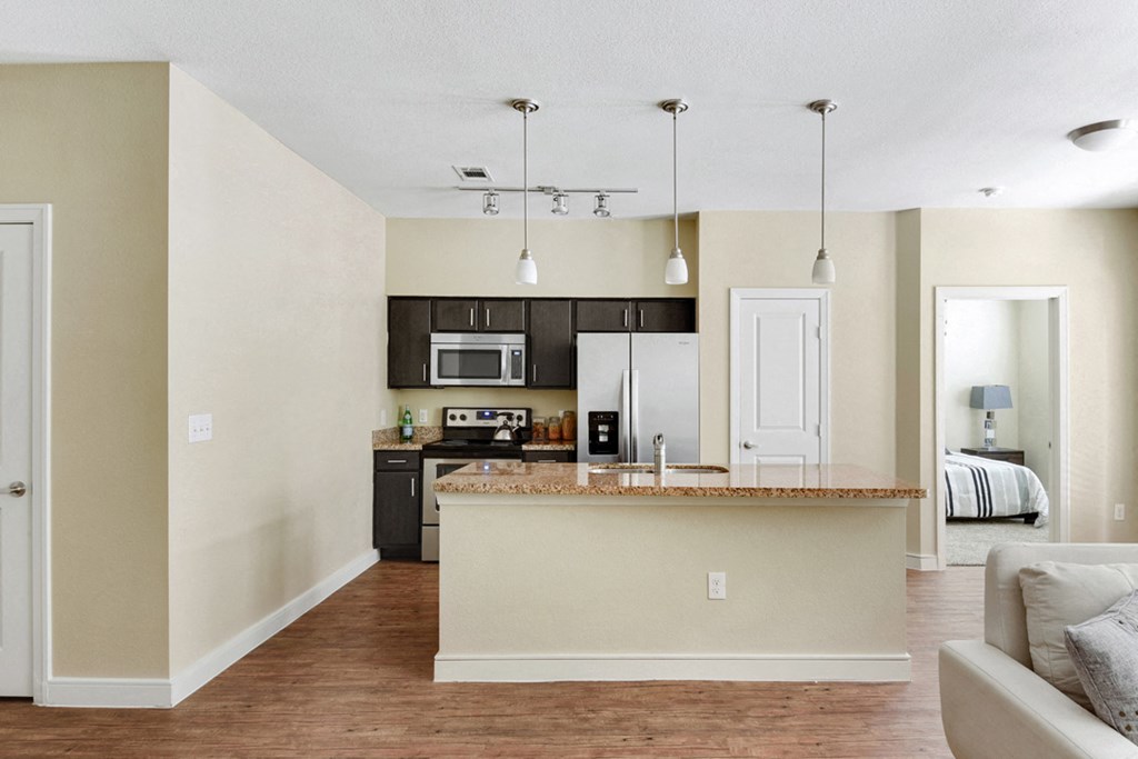 an open kitchen and living room with a counter top