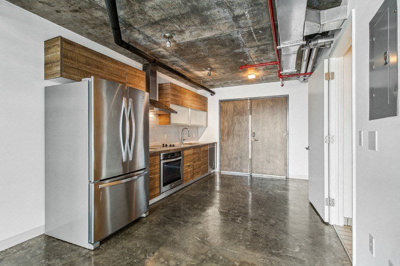 a kitchen with stainless steel appliances and a stainless steel refrigerator
