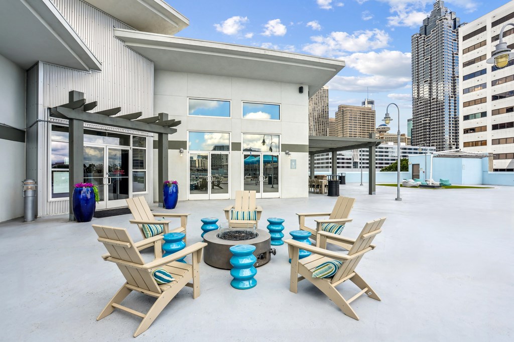 A white building with a patio area and chairs.