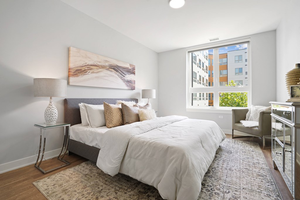 a bedroom with a large bed and a large window