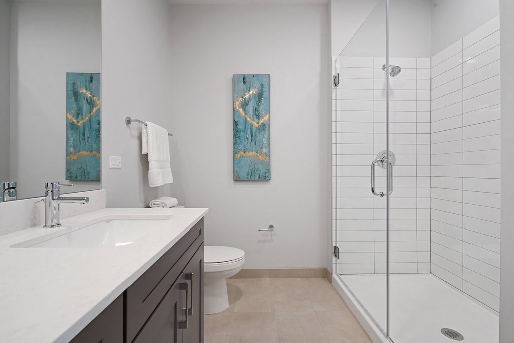 a bathroom with a toilet sink and shower