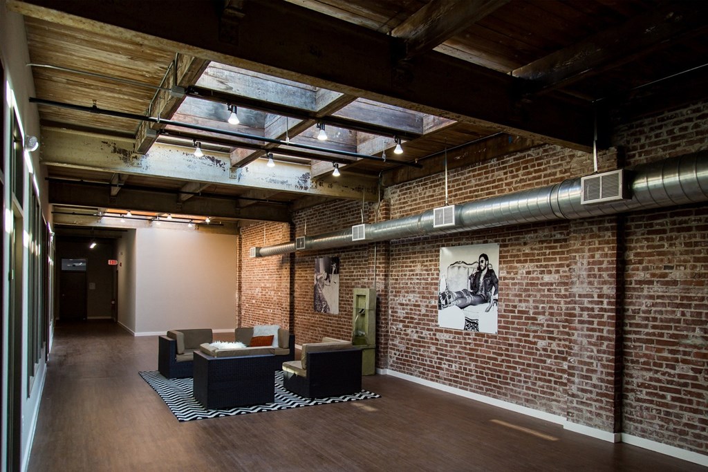 a room with a brick wall and a glass ceiling