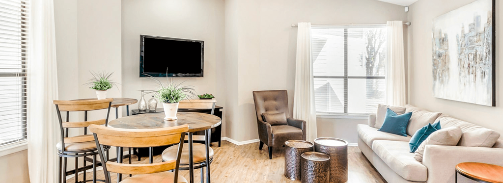 a living room with a table and a couch and a tv