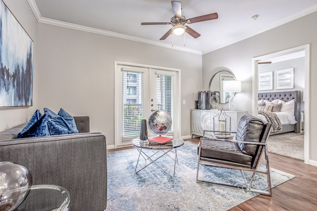 a living room with furniture and a ceiling fan