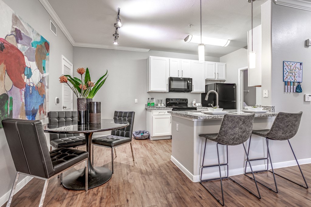 an open kitchen and dining area with a table and chairs