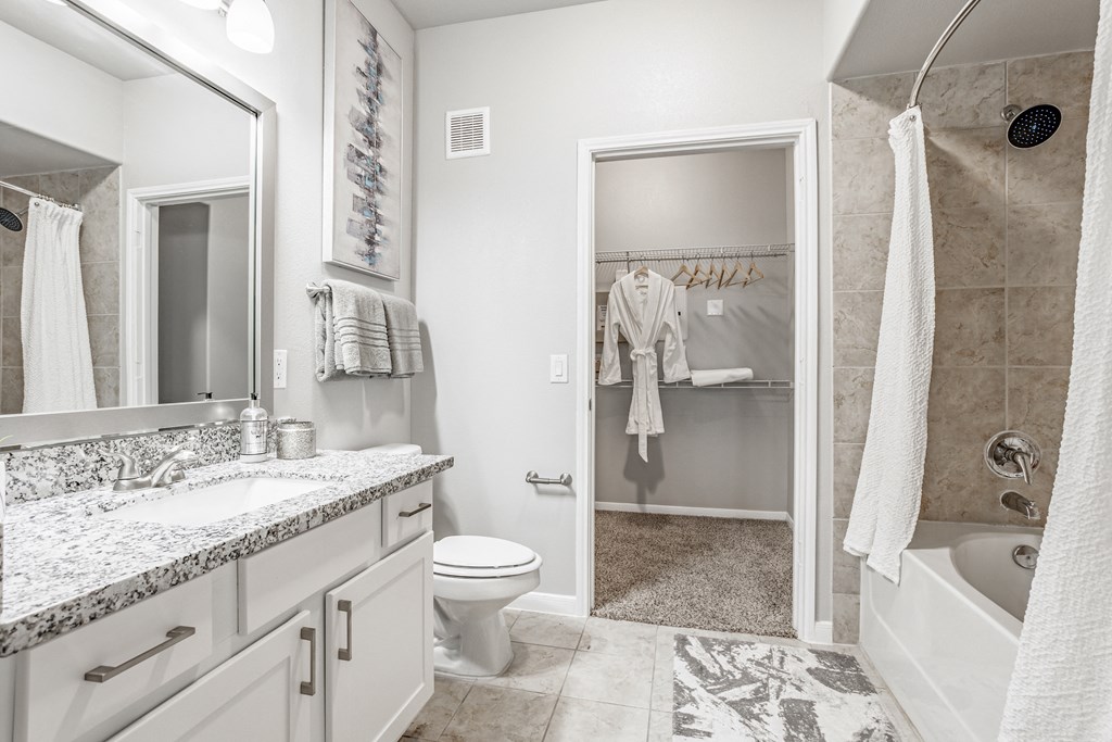 a bathroom with a shower and a sink and a toilet