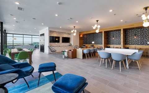A modern dining room with a long table and chairs.