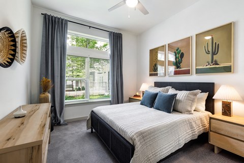 a bedroom with a bed and a large window
