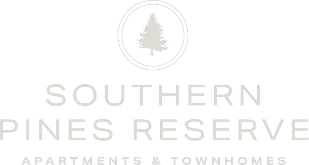 A logo with a tree and the words "Southern Pines Reserve Apartments & Townhomes" on a light background.