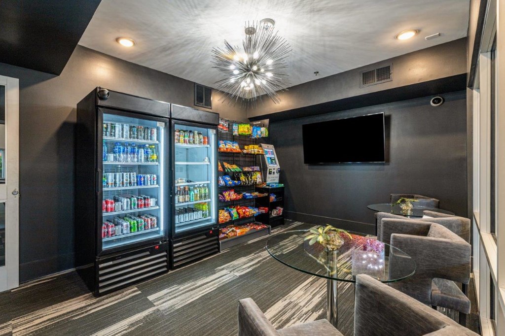 a room with a table and chairs and a tv on the wall
