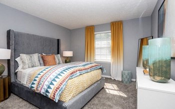 Primary model bedroom with queen bed and natural lighting. - Photo Gallery 6