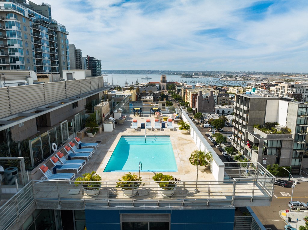 an aerial view of a swimming pool on the roof of a building in a city