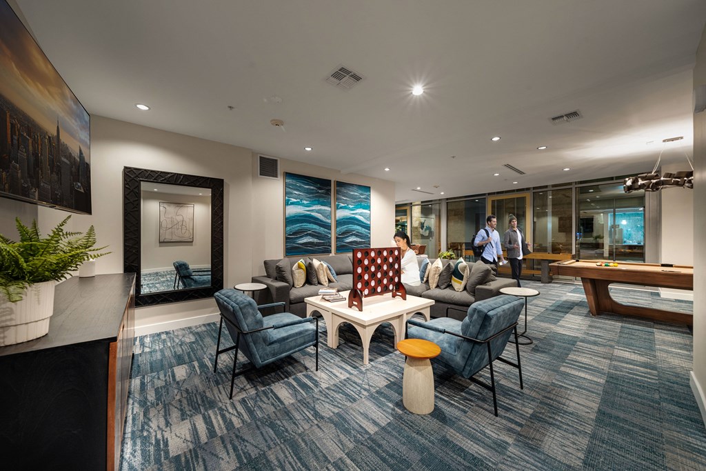 a living room with couches and chairs and a table