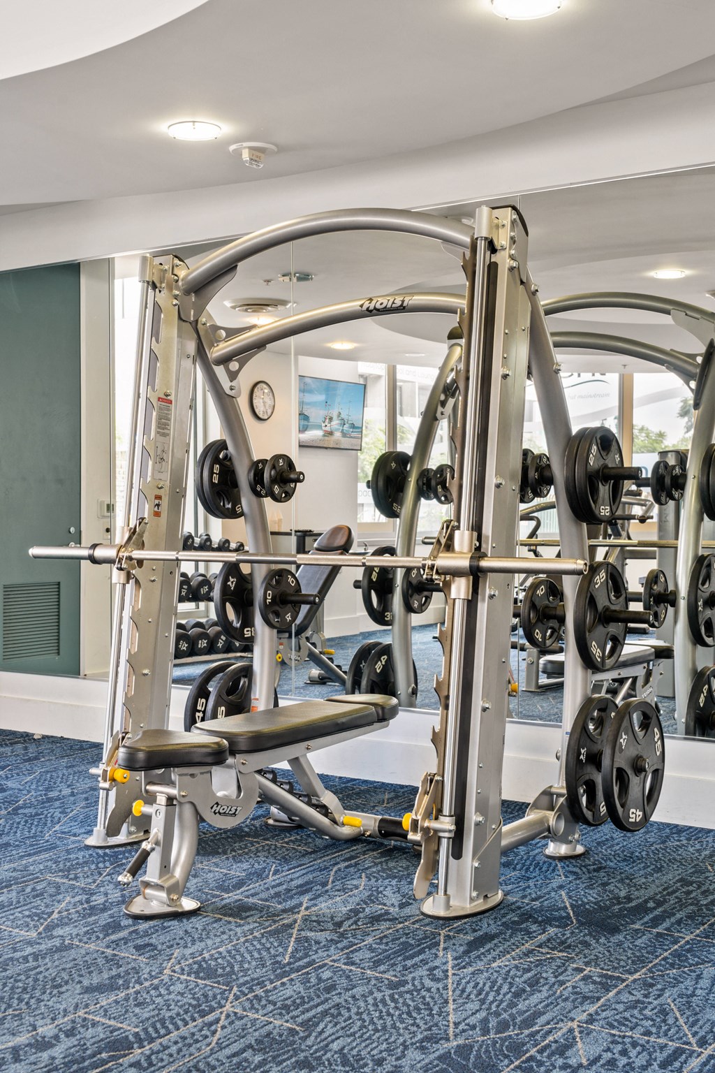a gym with weights and cardio equipment in a hotel room