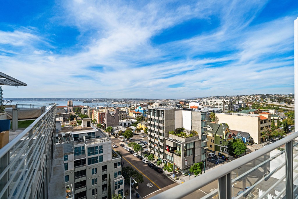 views of the city and the ocean from an apartment balcony