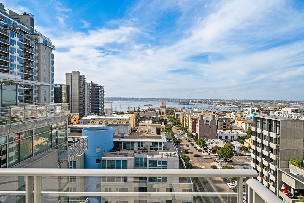 the view of the city from the balcony of an apartment building