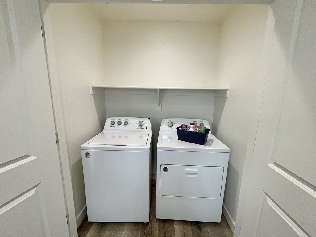 an empty laundry room with two washes and a dryer