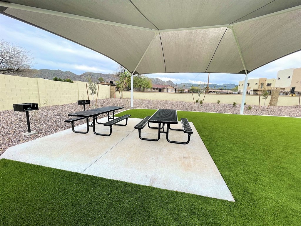 a picnic area with picnic tables under a tent