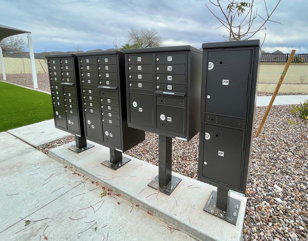 a row of mailboxes on a concrete pedestal on a sidewalk