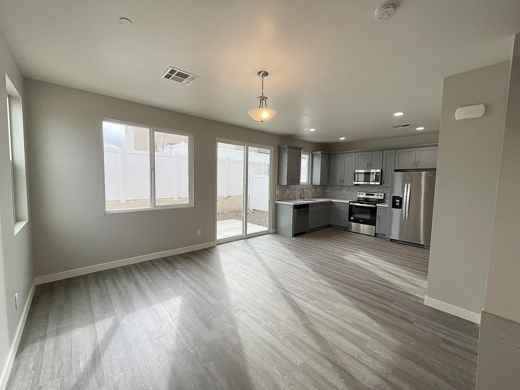 an empty living room and kitchen in a new home
