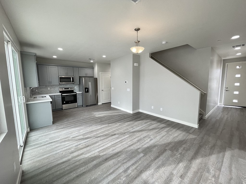 an empty living room and kitchen in a new home