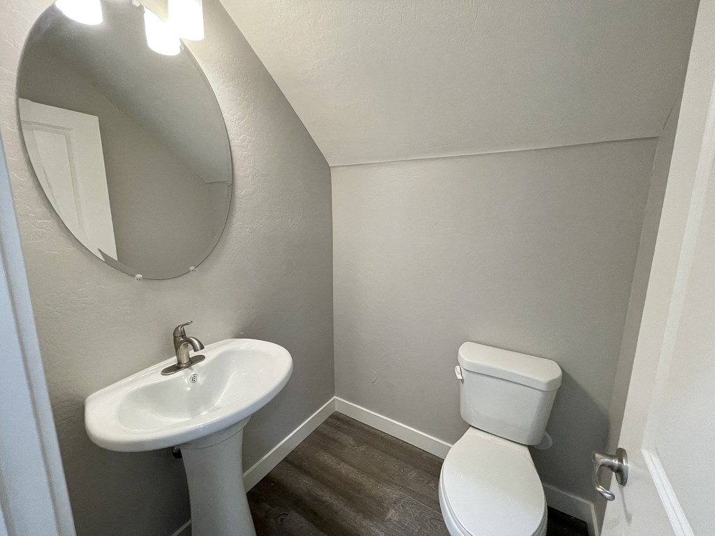 a small bathroom with a sink toilet and a mirror