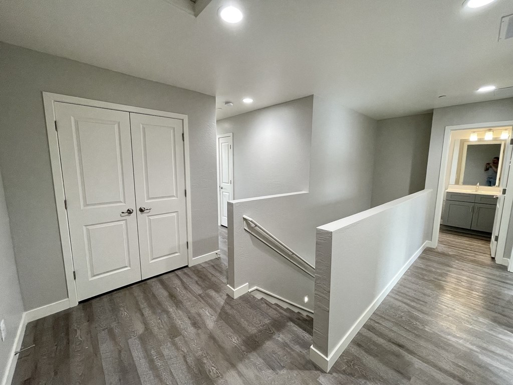 the landing of a new home with white doors and a staircase