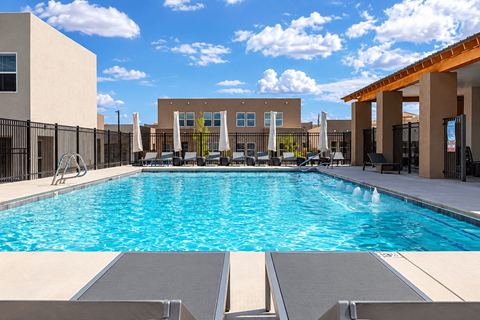 A large swimming pool in front of a building.