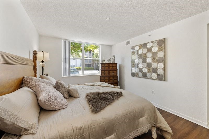 the master bedroom has a large bed and a window