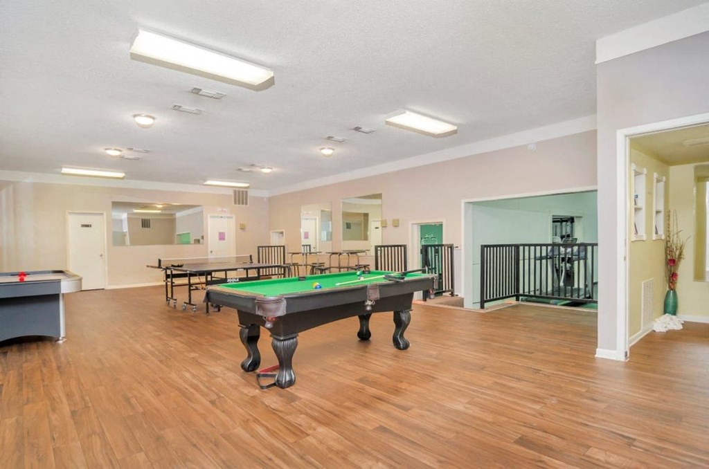 A room with a pool table and a ping pong table.
