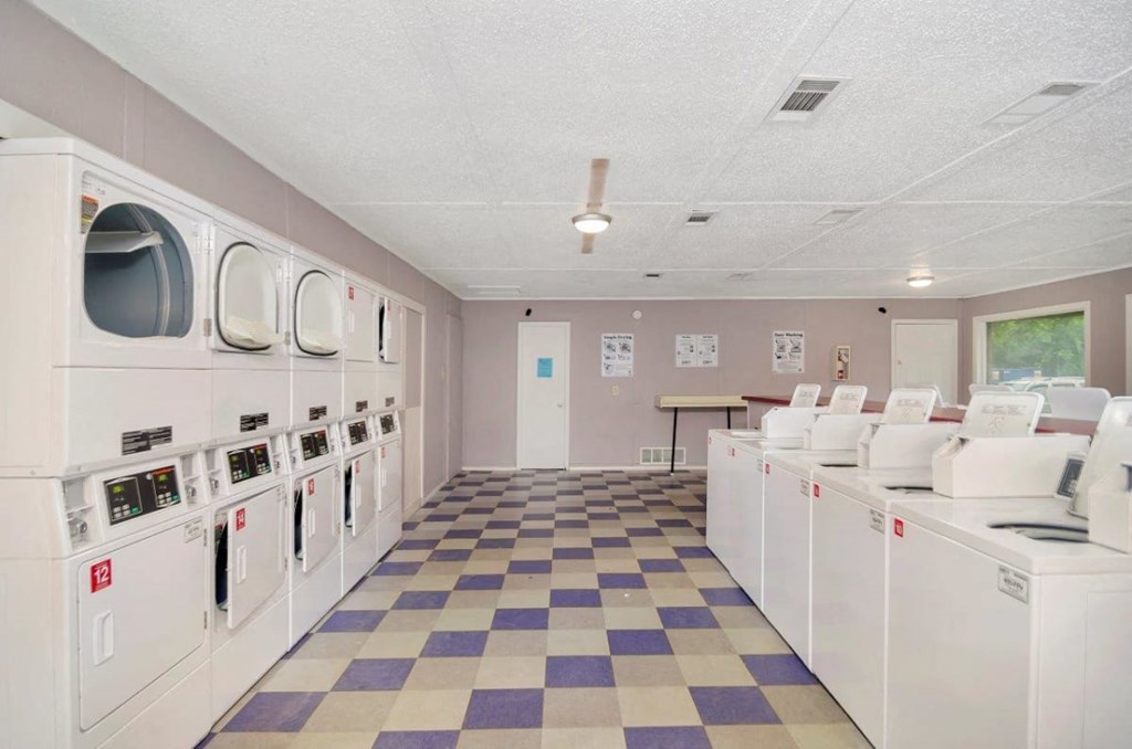 A laundromat with rows of washers and dryers.