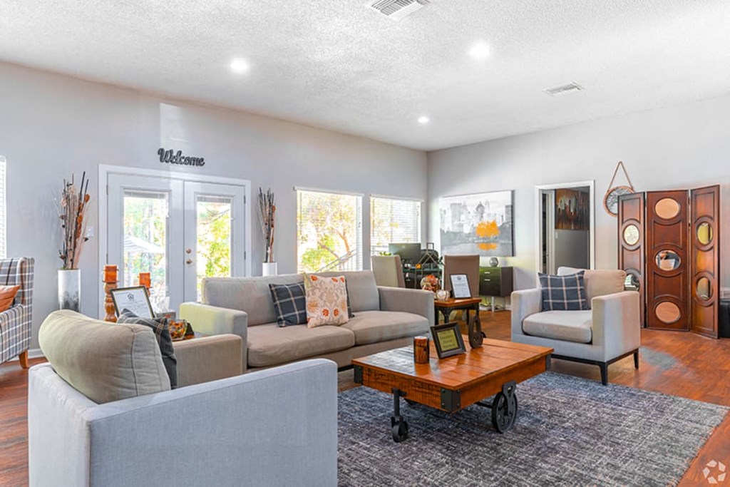 a living room with couches and chairs and a coffee table