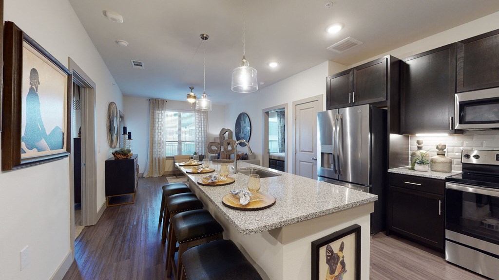 a kitchen with a large island and black cabinets