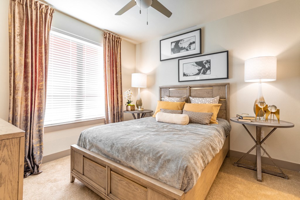 a bedroom with a bed and a ceiling fan