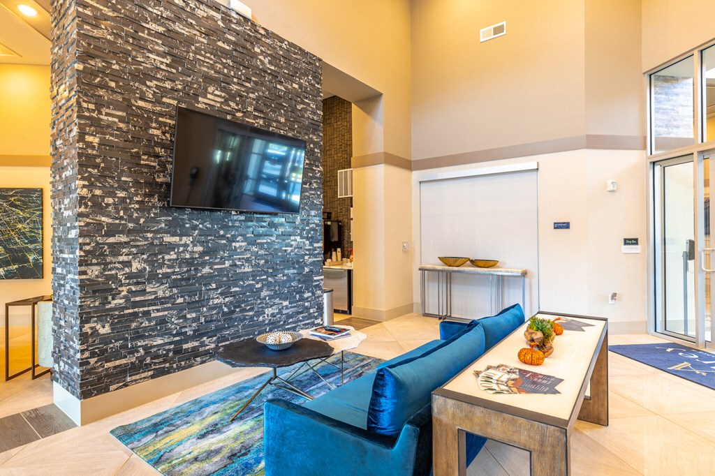 a living room with a blue couch and a television