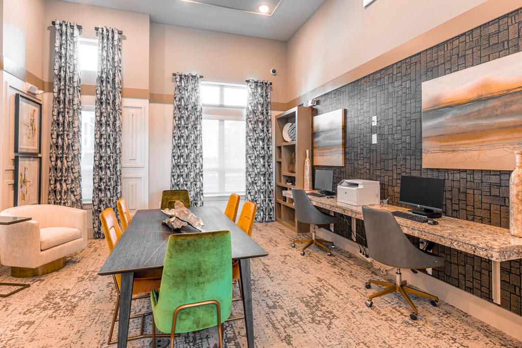 a conference room with a table and chairs and a desk with a computer